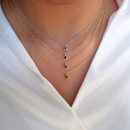 Necklace with small black stones on a white shirt